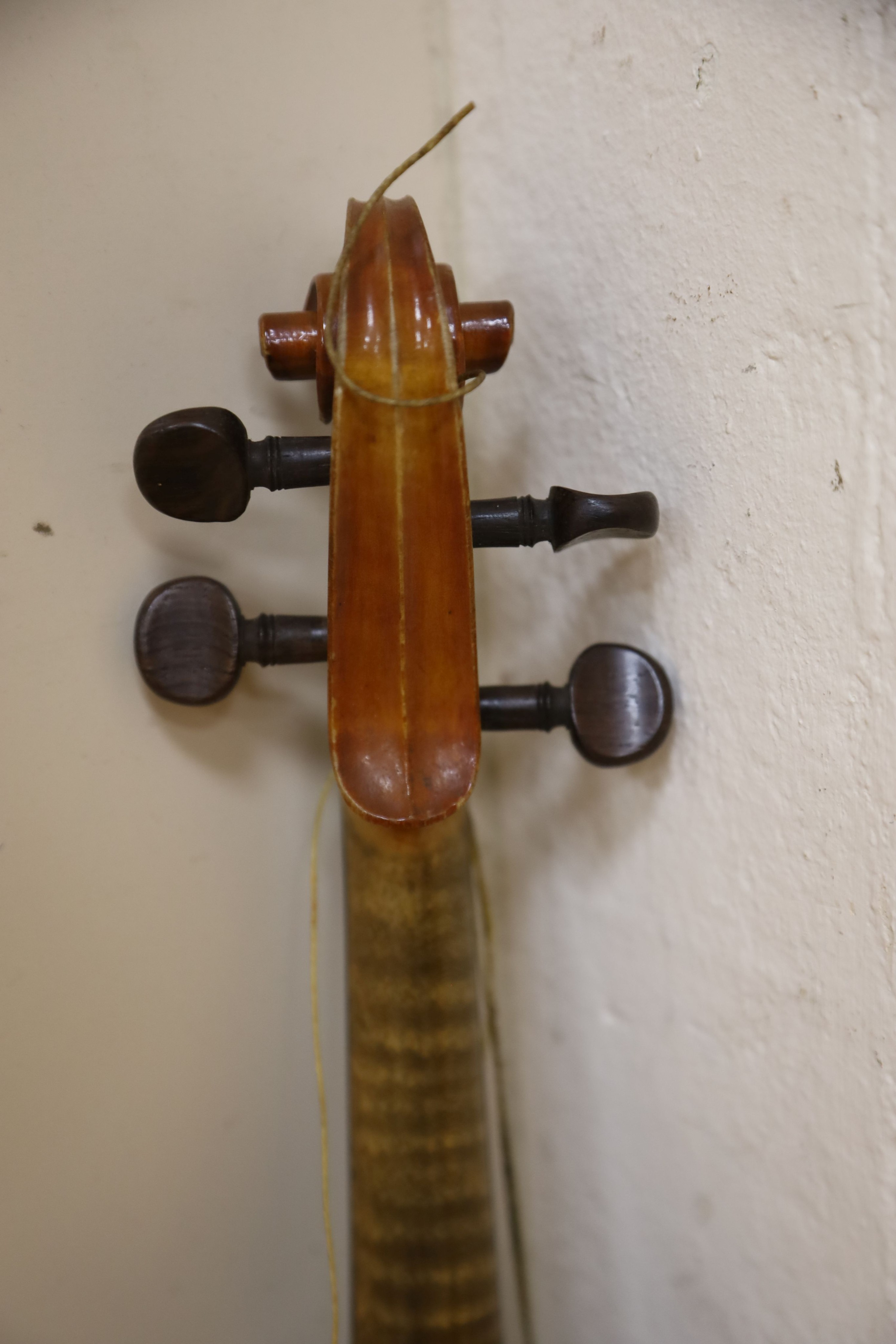 A Stradivarius copy violin and two bows and another bow, both cased, backs 33cm and 30cm